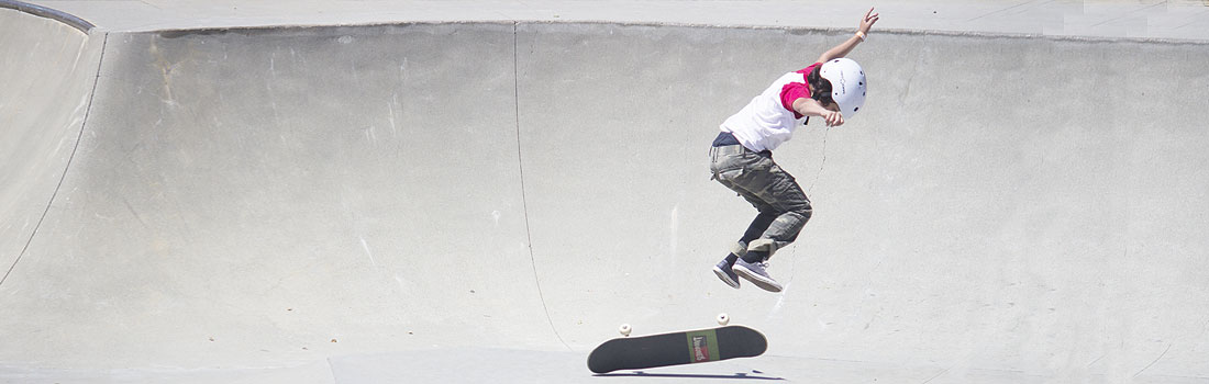 Kid doing a trick at the skatepark.