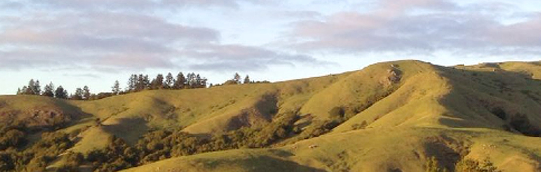 Scenic view of White Hill against a blue sky and clouds